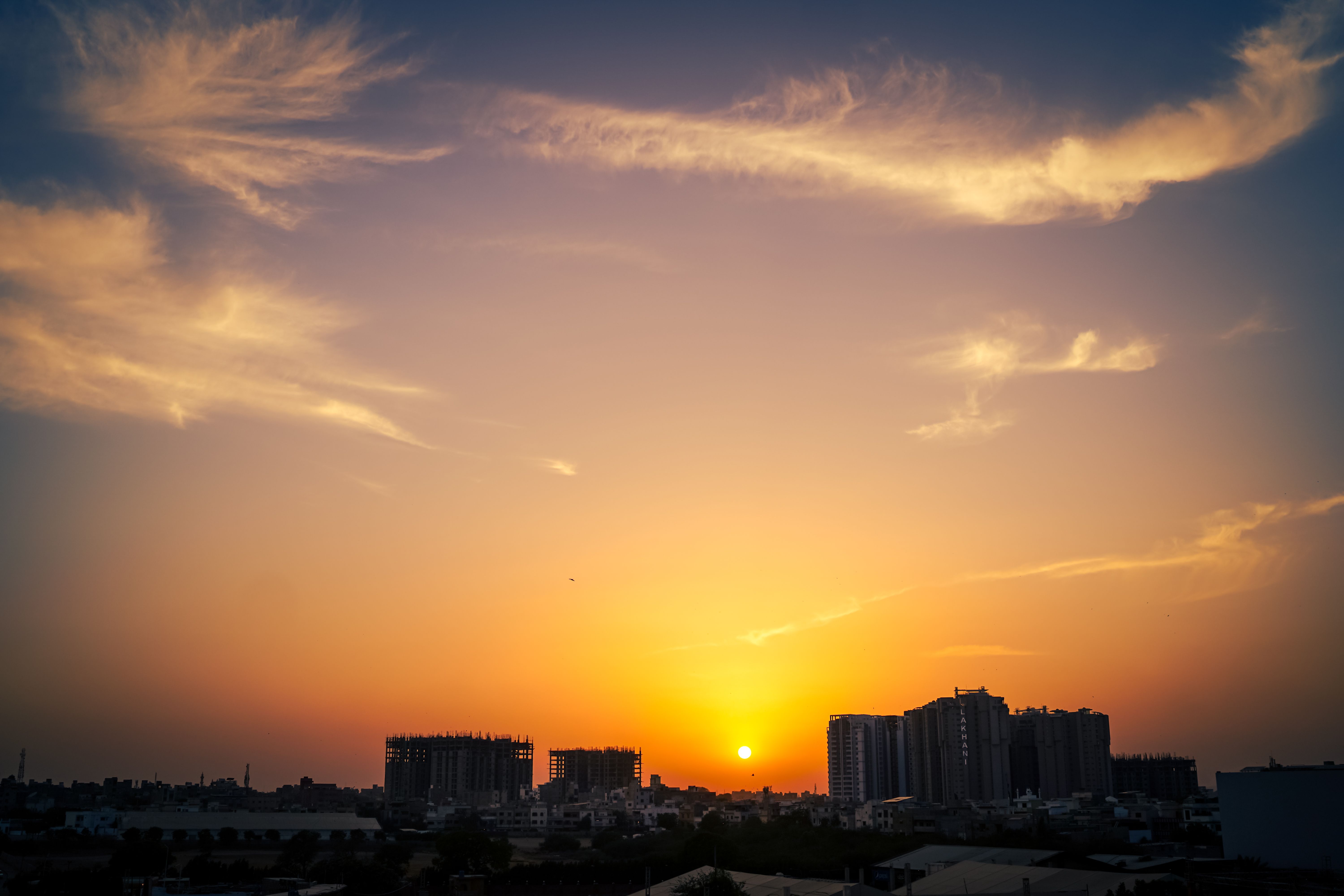 Karachi skyline at sunset with high-rise buildings