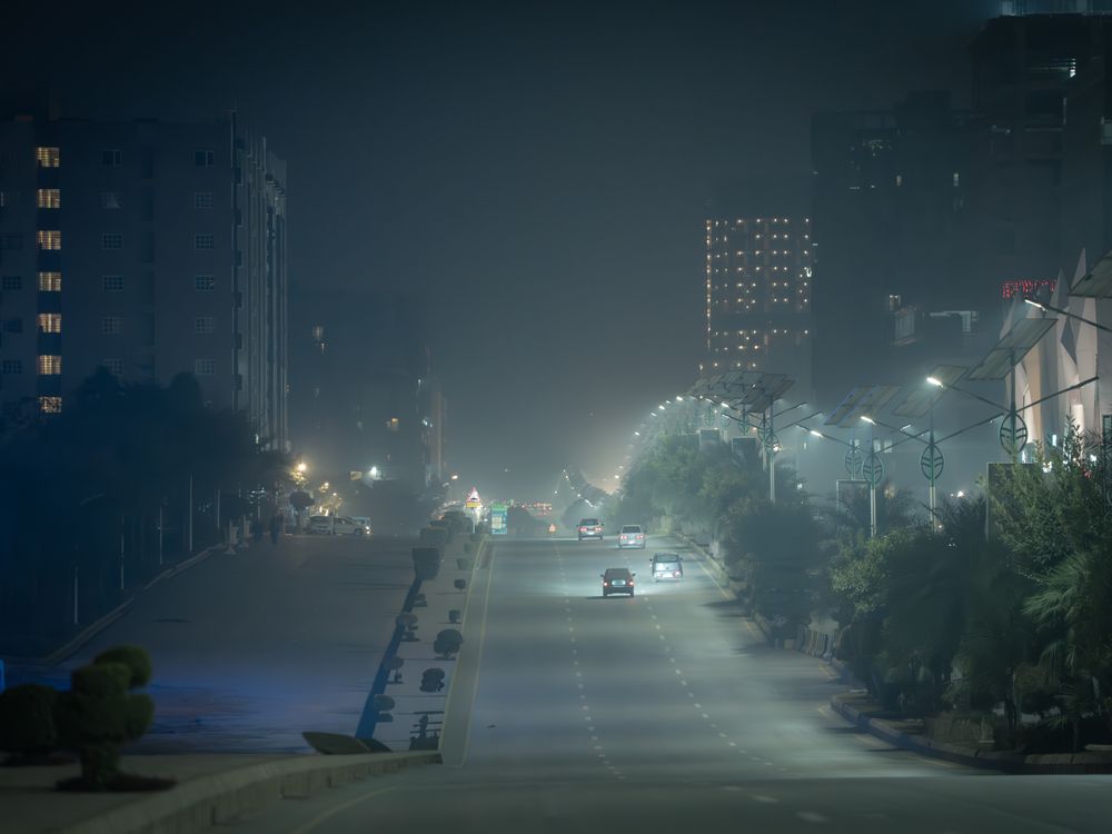 Evening city lights along a Peshawar street